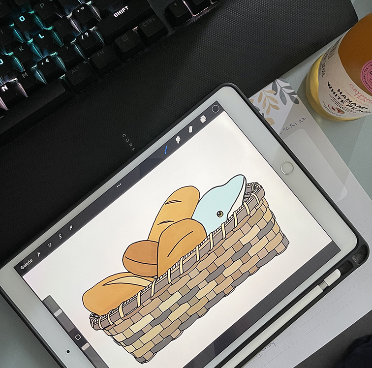 Drawing on iPad of a blue dolphin in a bread basket.